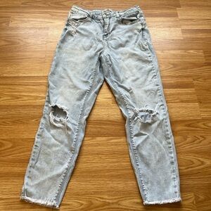 Light wash distressed boyfriend jeans with a raw hem